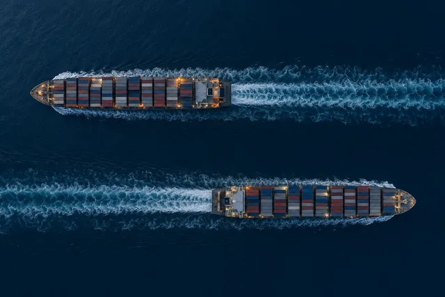 Two container ships passing each other in opposite directions, seen from above