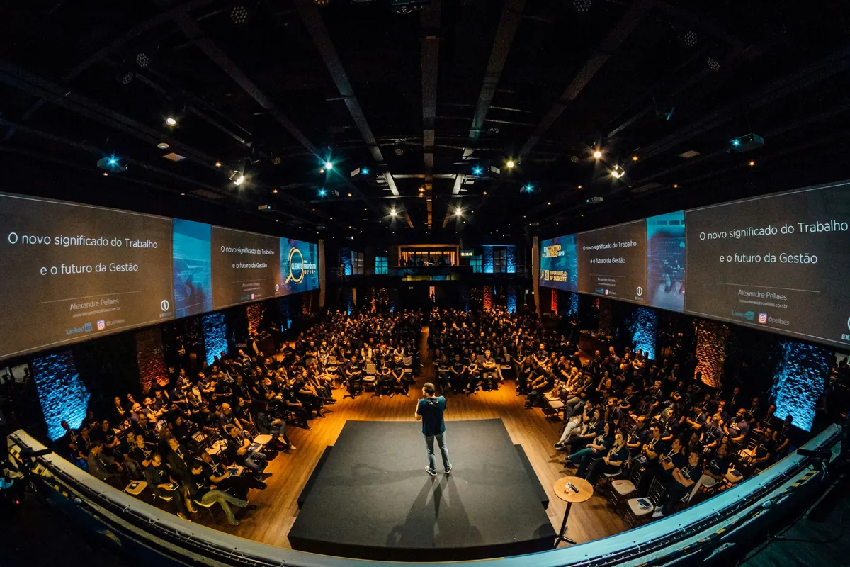 A large conference hall with rows of seats facing a stage