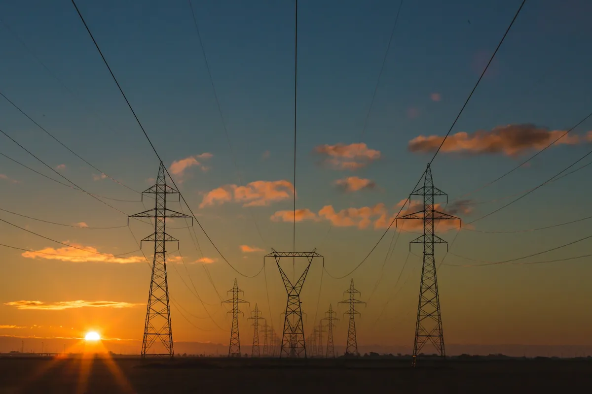High-voltage power lines at sunset